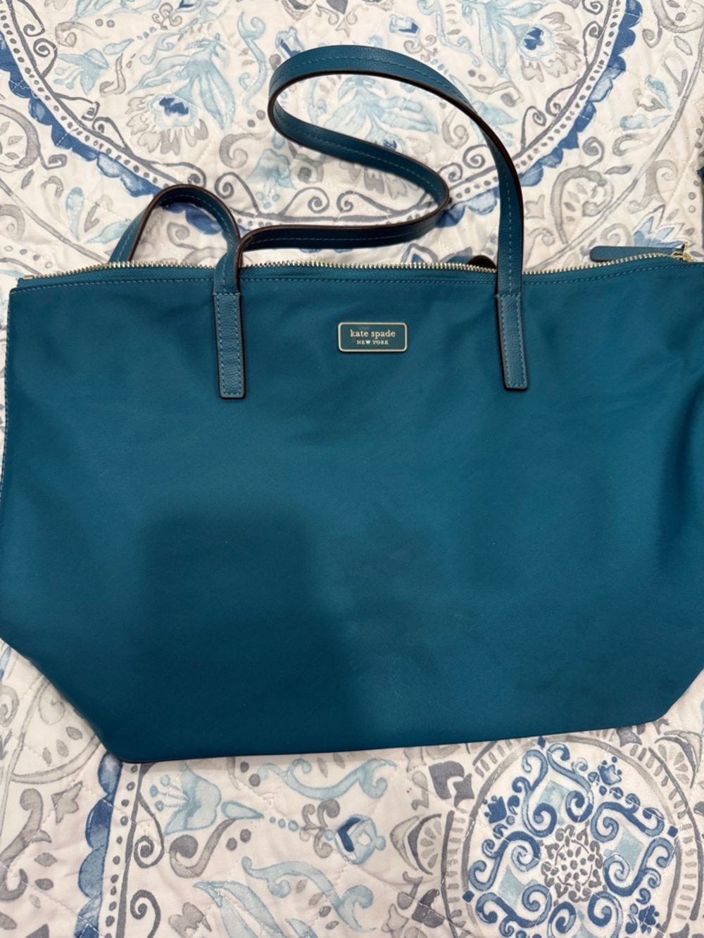 kate spade teal blue nylon tote with logo plaque. Small stain on front
